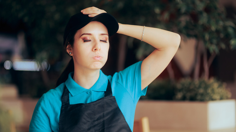 fast food worker showing signs of frustration