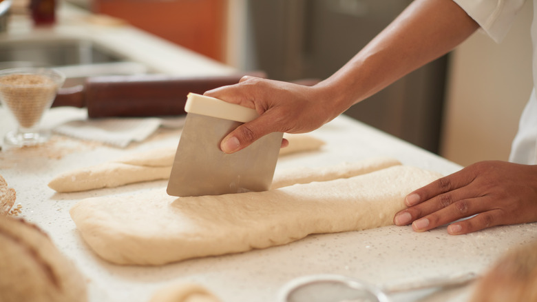 Pastry chef cutting dough
