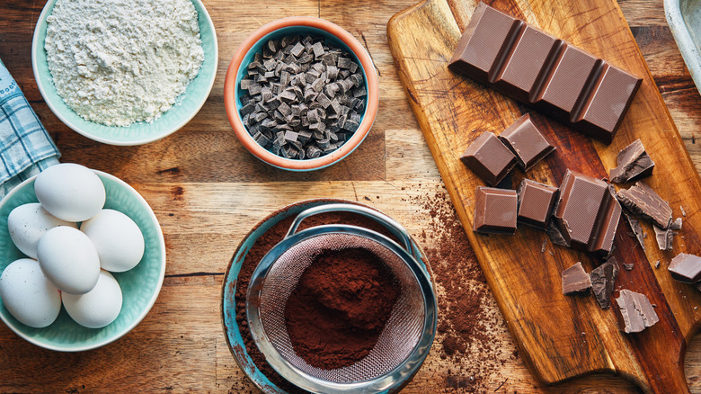 baking chocolate on cutting board surrounded by other ingredients