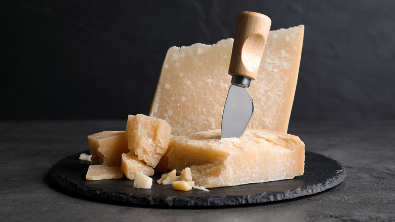 Parmesan cheese on cutting board