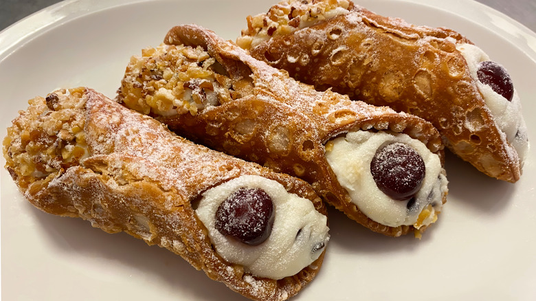 three cannolis on a plate
