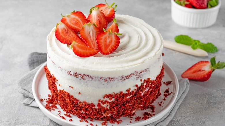 whole frosted cake with strawberries