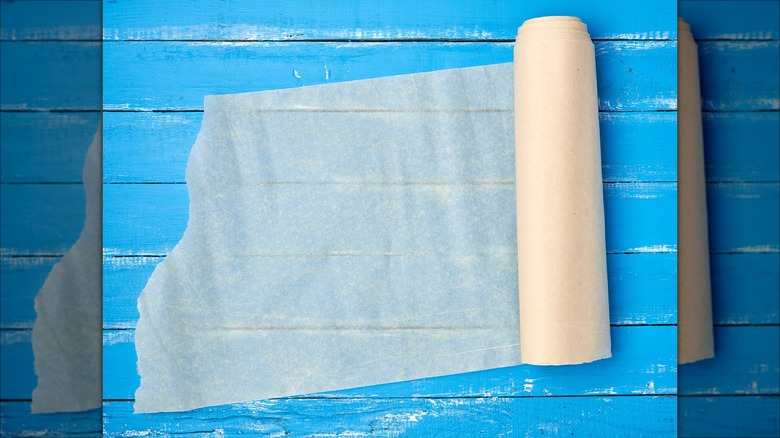 Unrolled parchment paper against blue panels