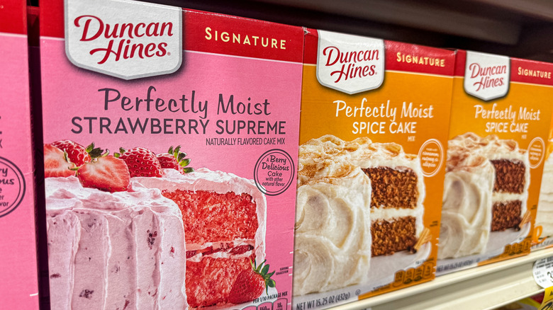 Boxed cake mixes on a grocery store shelf