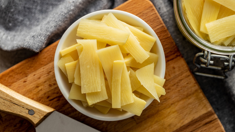 Bamboo shoots in bowl on cutting board