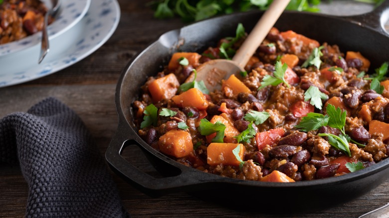 A skillet filled with beans and sweet potato