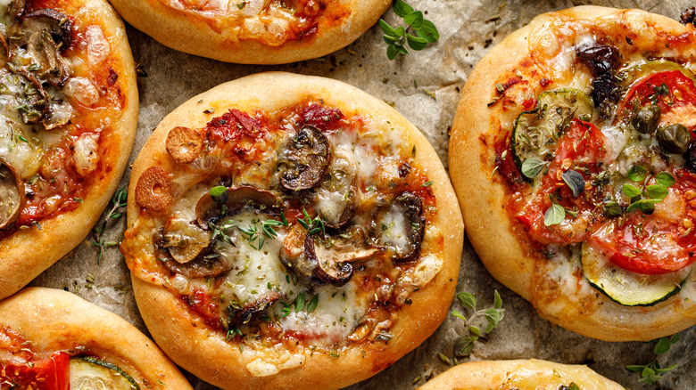 mini veggie pizzas touching edges golden brown