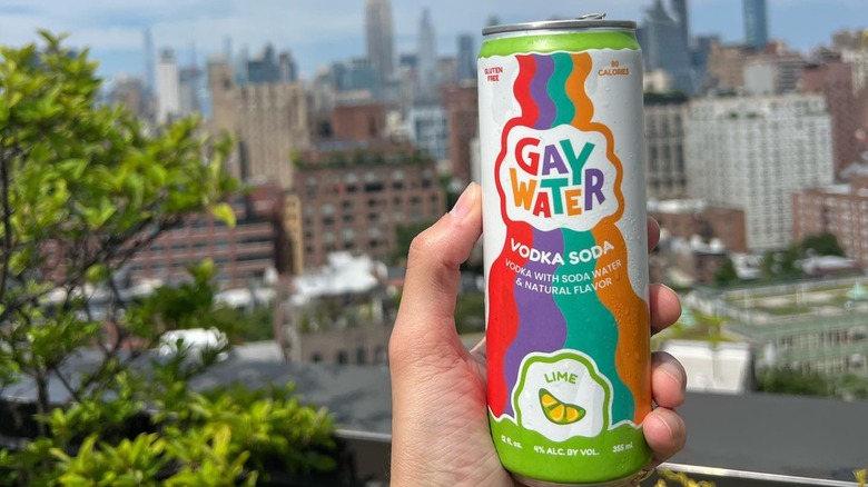 holding Gay Water over NYC skyline