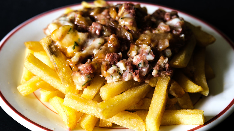 A plate of corned beef hash with fries