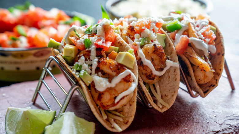 fish tacos topped with salsa avocado and sour cream