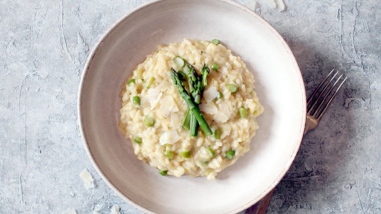 asparagus risotto in bowl on grey table