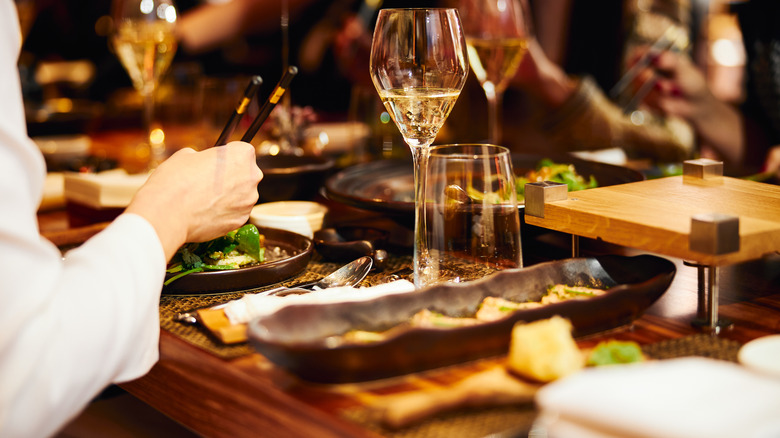 Restaurant dining with wine and chopsticks