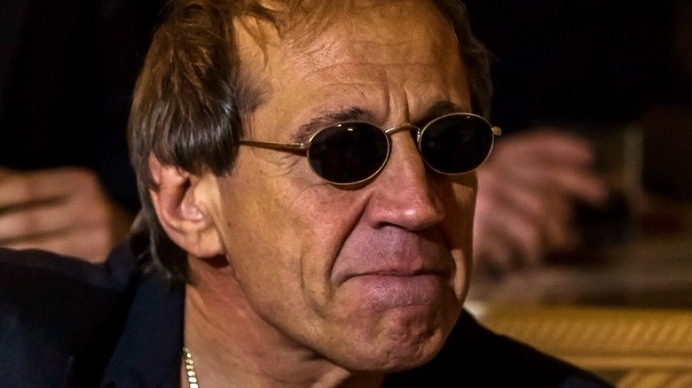 Adriano Celentano wearing small ovular sunglasses