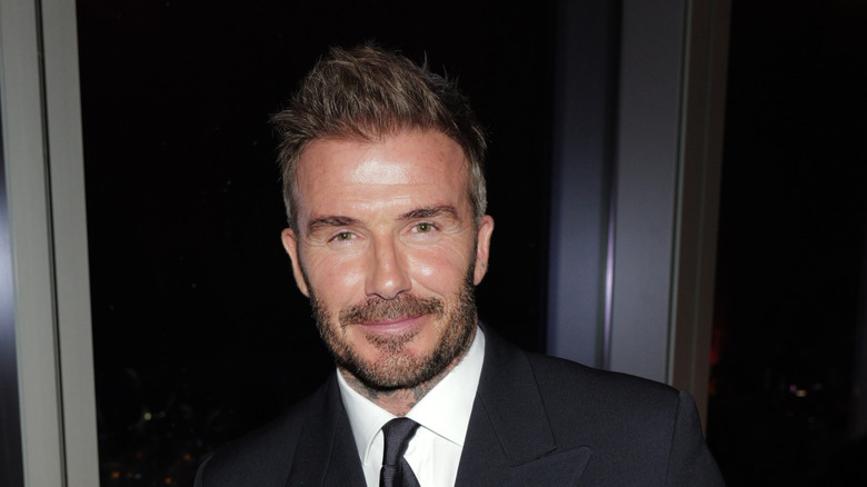 David Beckham wearing a black suit and tie