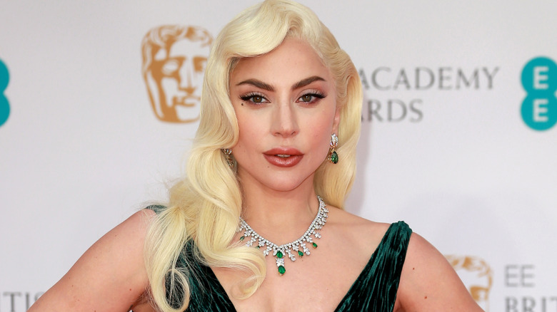 Lady Gaga wearing an emerald necklace and dress