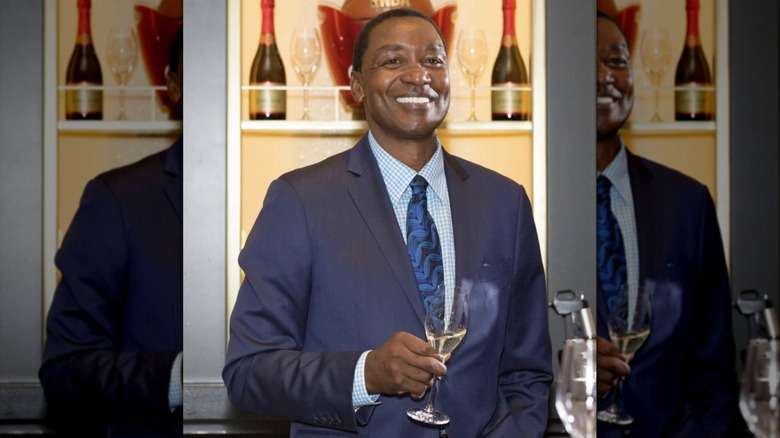 Isiah Thomas holding glass of champagne