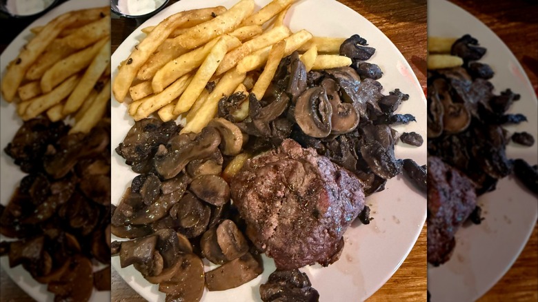 A filet steak covered in mushrooms and served with fries at Logan's Roadhouse