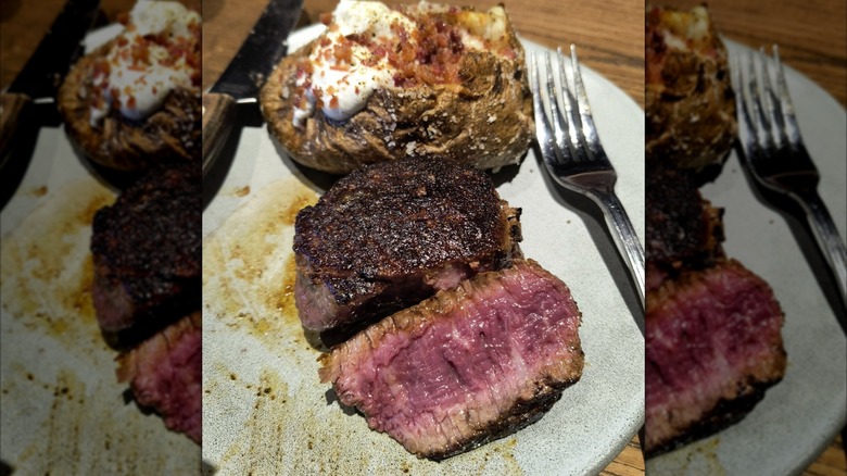 A filet mignon and baked potato served at Outback Steakhouse
