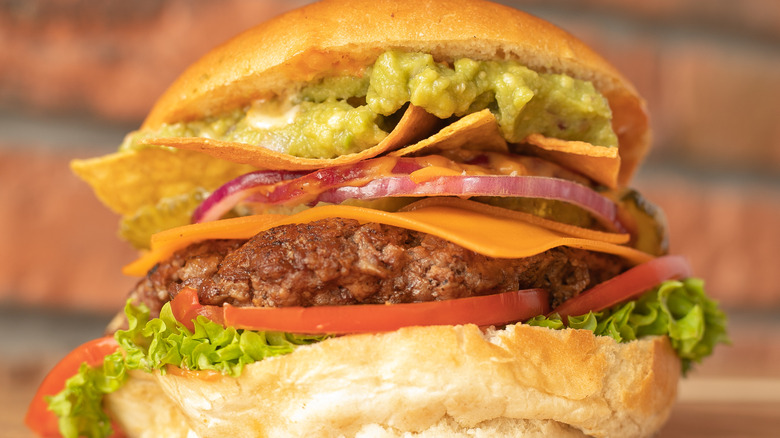 Hamburger with nachos and guacamole