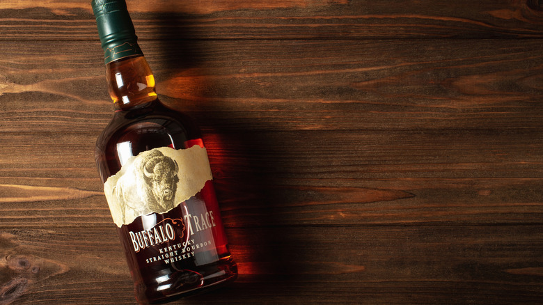Buffalo Trace bourbon bottle laying down on wooden table