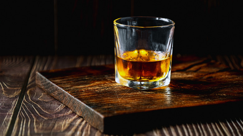 glass of whiskey on wood board