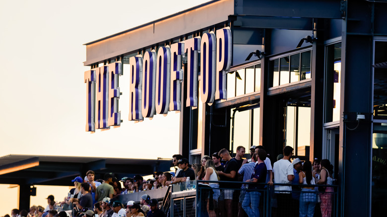 The Rooftop at Coors Field, with standing fans enjoying the game on a balcony