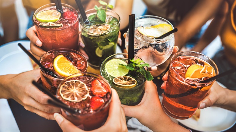 A group of people clinking glasses at Happy Hour