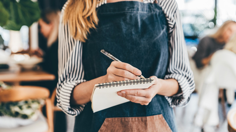 A server writes on a notepad
