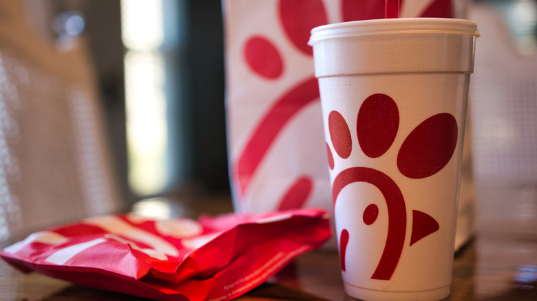 Red and white Chick-fil-A takeout containers and cup