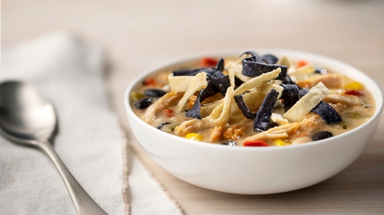 chicken tortilla soup next to a spoon