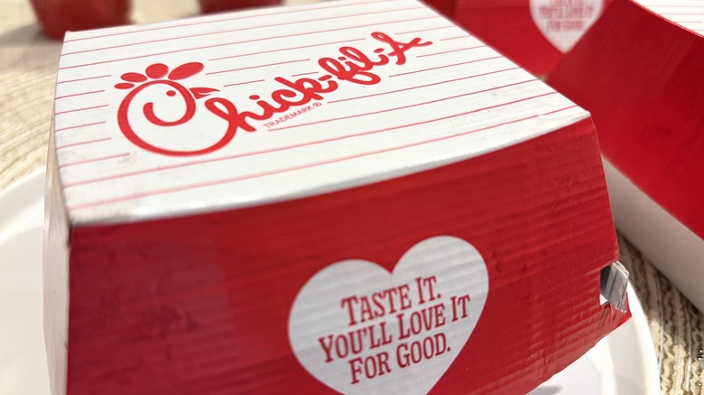 A closeup on a Chick-fil-A box with a heart on it