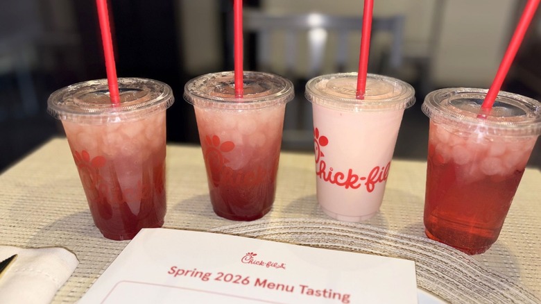 A lineup of Chik-fil-a drinks next to a menu