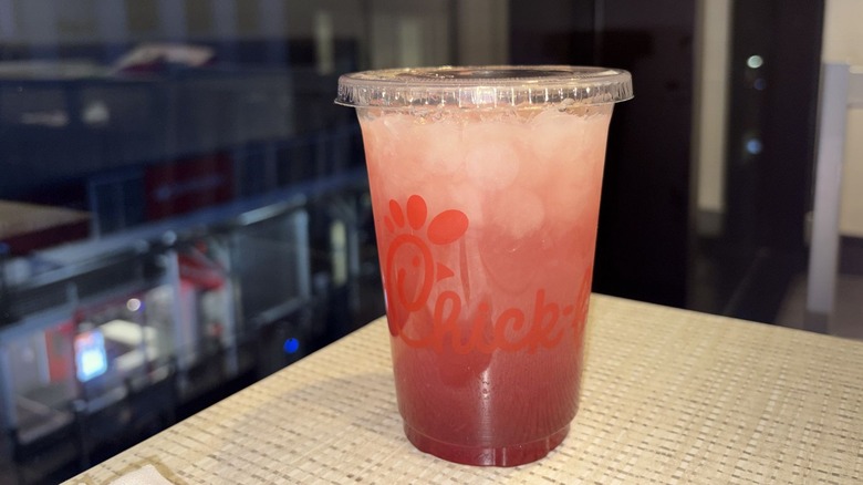 A closeup on a Strawberry Hibiscus Lemonade from chick-fil-a on a table