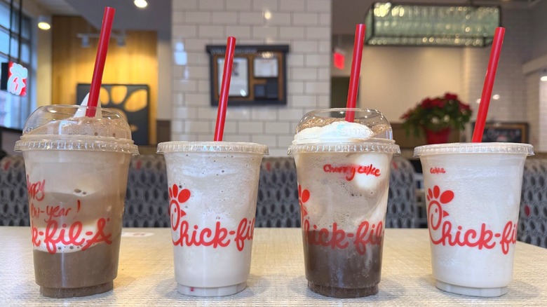 A lineup of Chick-fil-A frosted sodas and floats on a table
