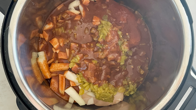 chicken cooked in the Instant Pot with green chiles enchilada sauce and onion
