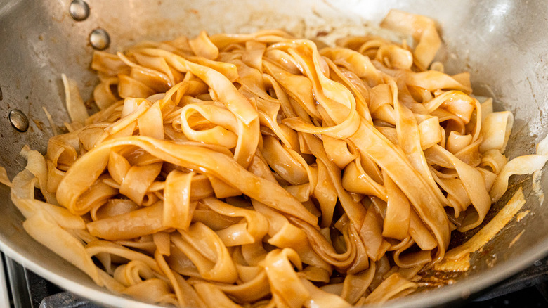saucy noodles in wok