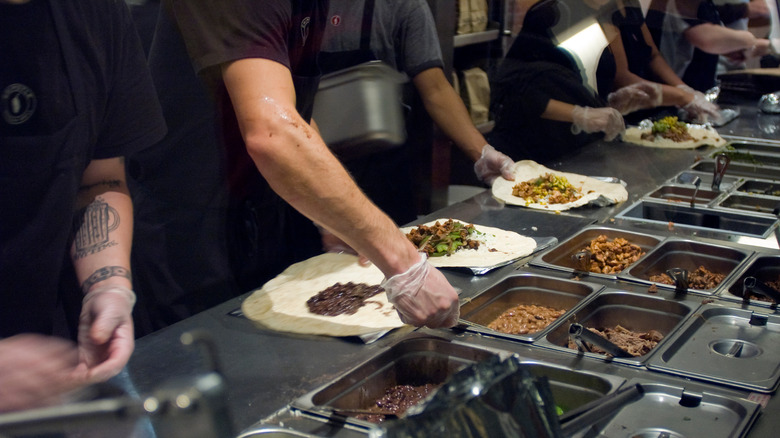 Chipotle workers making burritos