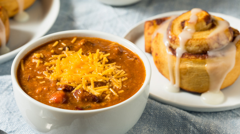 Bowl of chili and a cinnamon roll