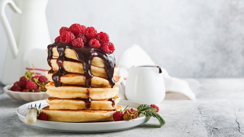 A plate of pancakes with toppings 