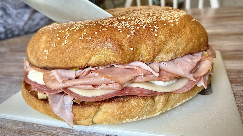 Large muffaletta sandwich on cutting board