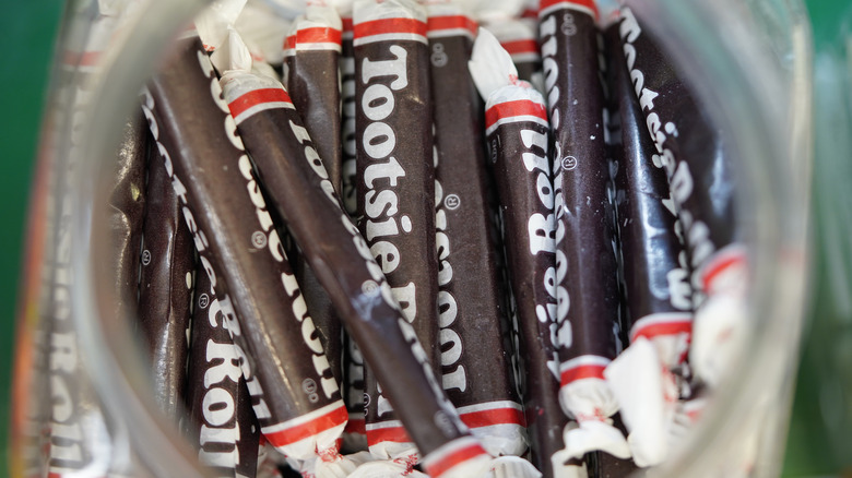 A close-up of a jar of Tootsie Rolls