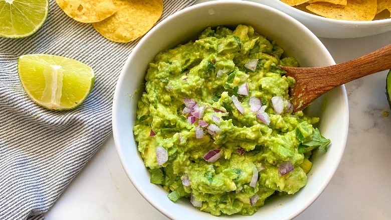 guacamole in a bowl with chips and lime  Fleet and Straightforward Guacamole stir well or chill 1664204141