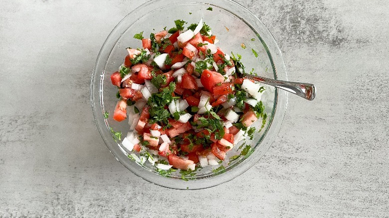 pico de gallo stirred up in glass bowl