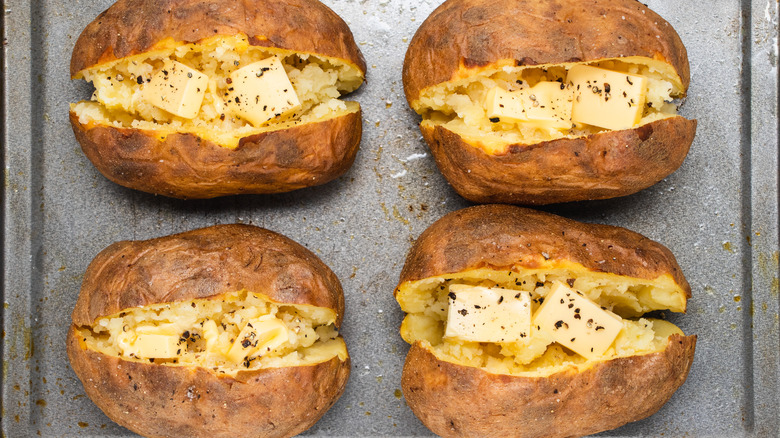 classic baked potatoes on tray 