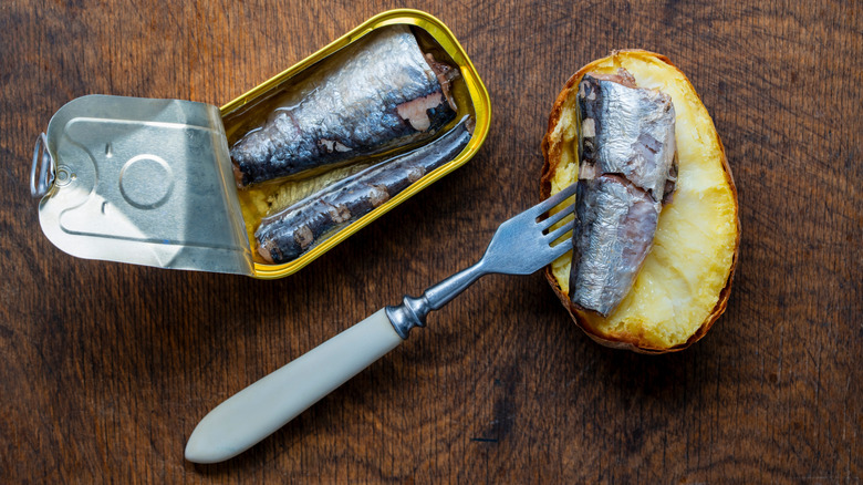 Can of sardines with buttered bread & fork