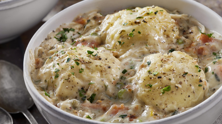 White bowl of chicken and dumplings