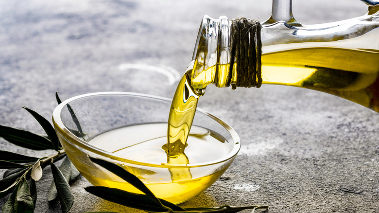 Olive oil poured into small glass bowl