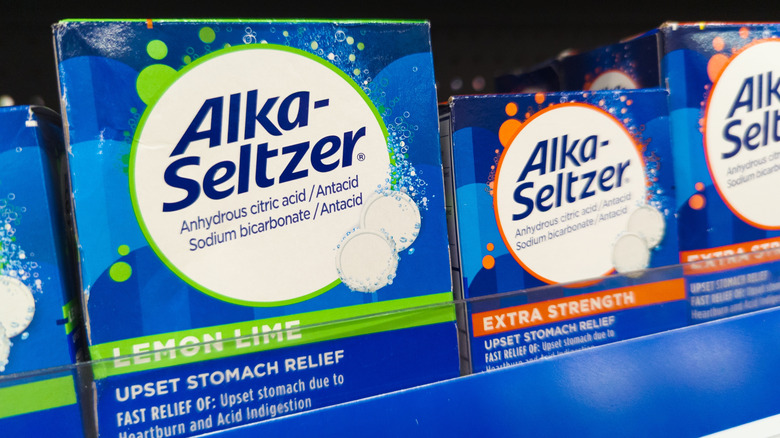 Boxes of different blue Alka-Seltzer tablets on a store shelf