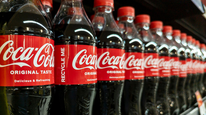 Bottles of Coke on store shelf
