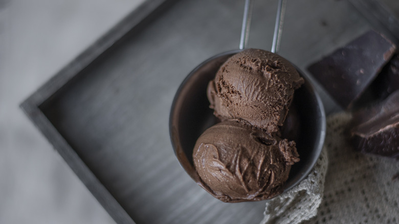 Dark chocolate ice cream on wood surface